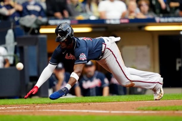 Jorge Soler of the Atlanta Braves slides safely into home to score a run in the third inning during Game 2 of the NLDS between the Atlanta Braves and...