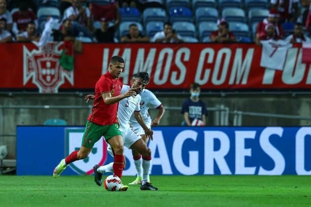 Andre Silva of RB Leipzig and Portugal tries to escape Tarek Salman of Qatar during the international friendly match between Portugal and Qatar at...