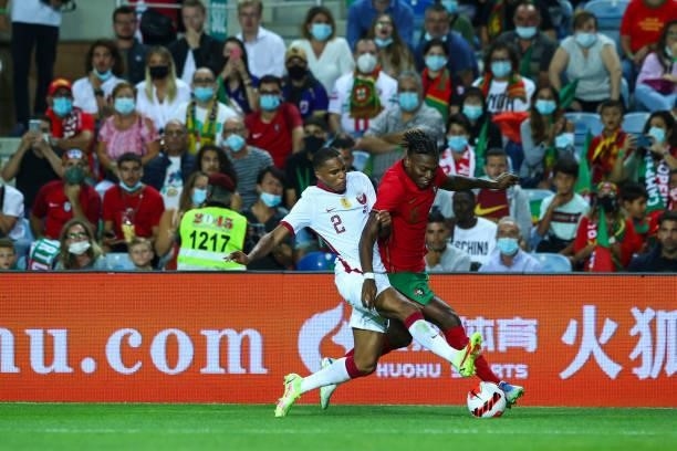 Rafael Leao of AC Milan and Portugal tries to escape Pedro Miguel of Qatar during the international friendly match between Portugal and Qatar at...