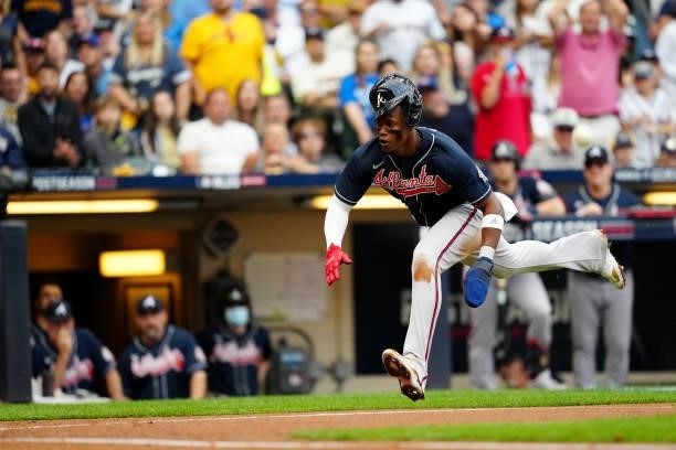 Jorge Soler of the Atlanta Braves slides safely into home to score a run in the third inning during Game 2 of the NLDS between the Atlanta Braves and...