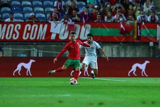 Cristiano Ronaldo of Manchester United and Portugal tries to escape Tarek Salman of Qatar during the international friendly match between Portugal...