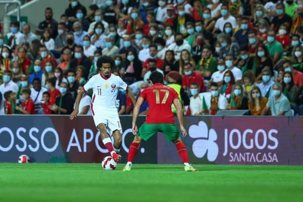 Akram Afif of Qatar tries to pass trough Goncalo Guedes of Valencia FC and Portugal during the international friendly match between Portugal and...