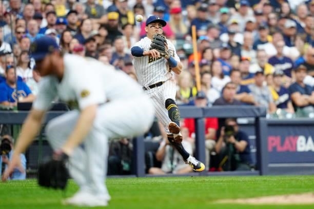 Luis Urias of the Milwuakee Brewers throws to first base for the out during Game 2 of the NLDS between the Atlanta Braves and the Milwaukee Brewers...