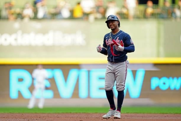 Ozzie Albies of the Atlanta Braves reacts to hitting a RBI double in the third inning during Game 2 of the NLDS between the Atlanta Braves and the...