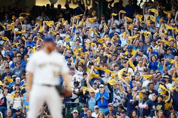 Fans are seen waving rally towels during Game 2 of the NLDS between the Atlanta Braves and the Milwaukee Brewers at American Family Field on...