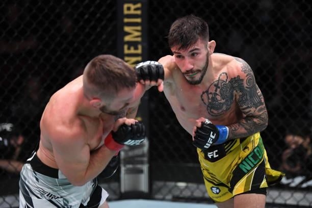 In this UFC handout, Matheus Nicolau of Brazil punches Tim Elliott in their flyweight bout during the UFC Fight Night event at UFC APEX on October...