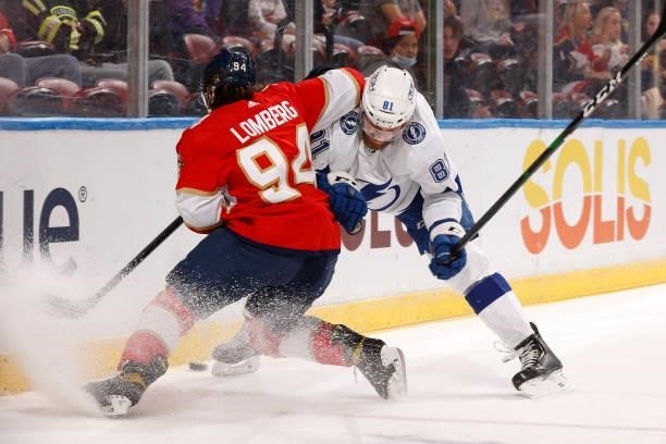 Erik Cernak of the Tampa Bay Lightning checks Ryan Lomberg of the Florida Panthers off the puck behind the net during a preseason game at the FLA...