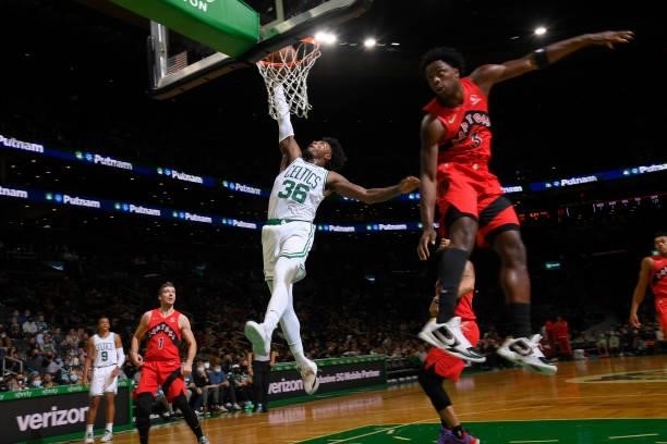 Marcus Smart of the Boston Celtics dunks the ball during a preseason game against the Toronto Raptors on October 9, 2021 at the TD Garden in Boston,...
