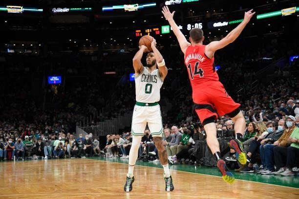 Jayson Tatum of the Boston Celtics shoots a three point basket during a preseason game against the Toronto Raptors on October 9, 2021 at the TD...