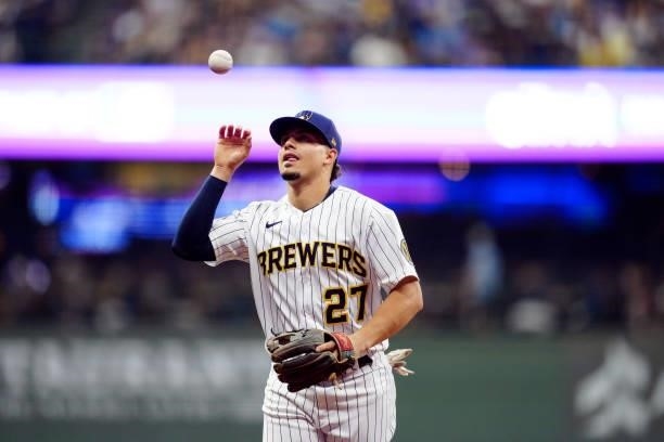 Willy Adames of the Milwaukee Brewers flips the ball in the air on the way back to the dugout during Game 2 of the NLDS between the Atlanta Braves...