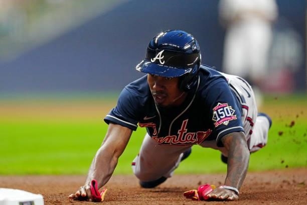 Terrance Gore of the Atlanta Braves dives back to first base on an attempted pick-off during Game 2 of the NLDS between the Atlanta Braves and the...
