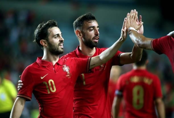Bernardo Silva and Bruno Fernandes of Portugal celebrate after Andre Silva of Portugal scored a goal during the international friendly match between...