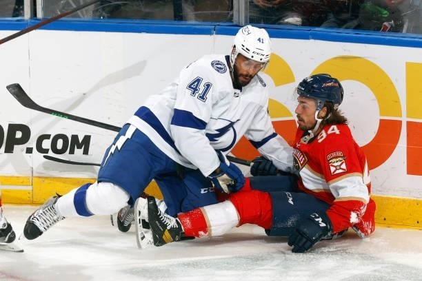 Pierre-Edouard Bellemare of the Tampa Bay Lightning checks Ryan Lomberg of the Florida Panthers during a preseason game at the FLA Live Arena on...