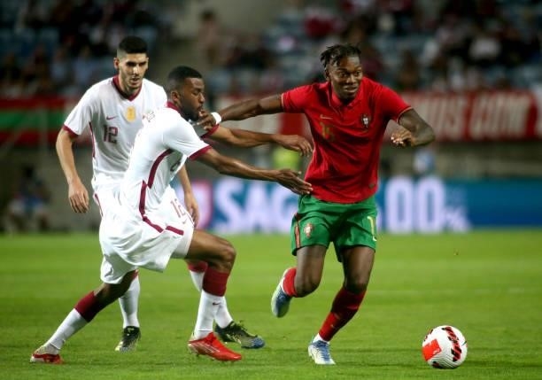 Rafael Leao of Portugal competes for the ball with Abdulaziz Hatem and Karim Boudiaf of Qatar during the international friendly match between...