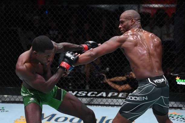 In this handout image provided by the UFC, Jared Gooden punches Randy Brown of Jamaica in their welterweight bout during the UFC Fight Night event at...