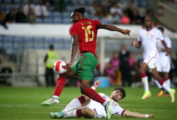 Rafael Leao of Portugal competes for the ball with Bassam Hisham of Qatar during the international friendly match between Portugal and Qatar at...