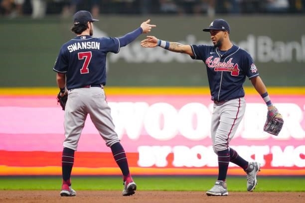 Dansby Swanson and Eddie Rosario of the Atlanta Braves celebrate after the Braves defeated the Milwaukee Brewers 3-0 in Game 2 of the NLDS at...