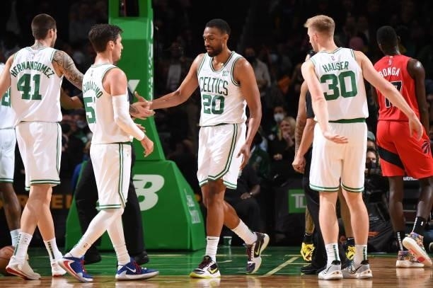 Jabari Parker of the Boston Celtics high fives Juancho Hernangomez of the Boston Celtics during a preseason game against the Toronto Raptors on...