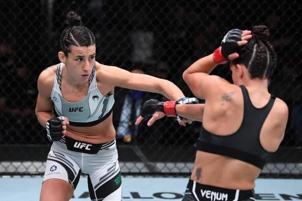 In this handout image provided by the UFC, Marina Rodriguez of Brazil punches Mackenzie Dern in their women's strawweight bout during the UFC Fight...