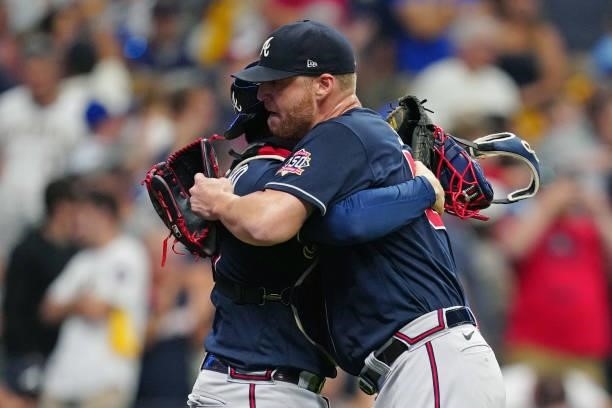 Will Smith and Travis d'Arnaud of the Atlanta Braves hug after the Braves defeated the Milwaukee Brewers 3-0 in Game 2 of the NLDS at American Family...