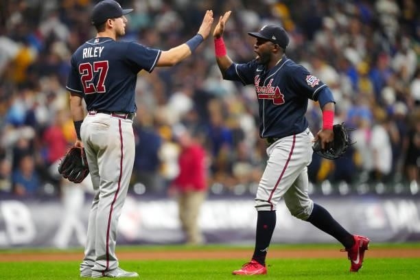 Austin Riley and Guillermo Heredia of the Atlanta Braves celebrate after the Braves defeated the Milwaukee Brewers 3-0 in Game 2 at American Family...