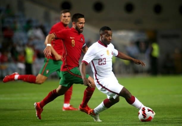 Assim Madibo of Qatar competes for the ball with Joao Moutinho of Portugal ,during the international friendly match between Portugal and Qatar at...
