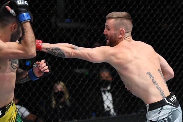 In this handout image provided by the UFC, Tim Elliott punches Matheus Nicolau of Brazil in their flyweight bout during the UFC Fight Night event at...