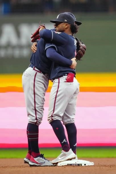 Ozzie Albies of the Atlanta Braves hugs a teammate after the Braves defeated the Milwaukee Brewers 3-0 in Game 2 of the NLDS at American Family Field...