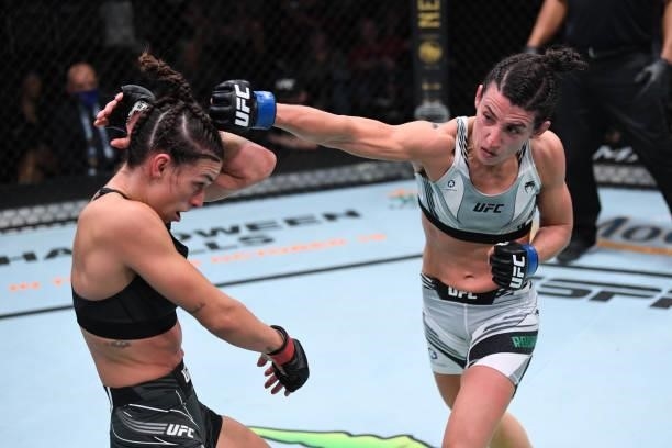 In this handout image provided by the UFC, Marina Rodriguez of Brazil punches Mackenzie Dern in their women's strawweight bout during the UFC Fight...
