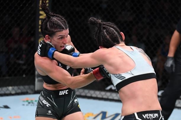 In this handout image provided by the UFC, Mackenzie Dern punches Marina Rodriguez of Brazil in their women's strawweight bout during the UFC Fight...