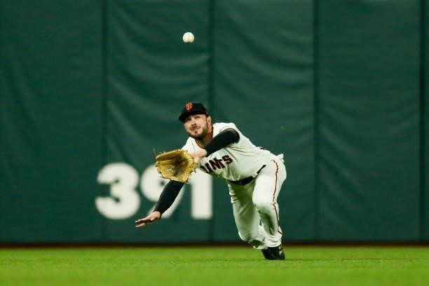 Kris Bryant of the San Francisco Giants catches a fly ball in the seventh inning during Game 2 of the NLDS between the Los Angeles Dodgers and the...
