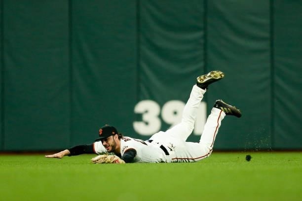 Kris Bryant of the San Francisco Giants catches a fly ball in the seventh inning during Game 2 of the NLDS between the Los Angeles Dodgers and the...