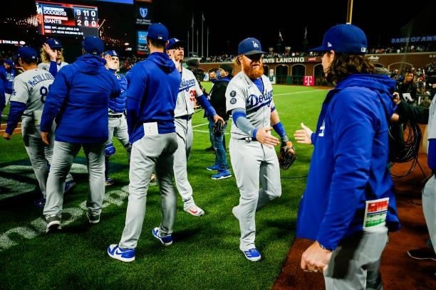 Members of the Los Angeles Dodgers celebrate after beating the San Francisco Giants 9-2 in Game 2 of the NLDS at Oracle Park on Saturday, October 9,...