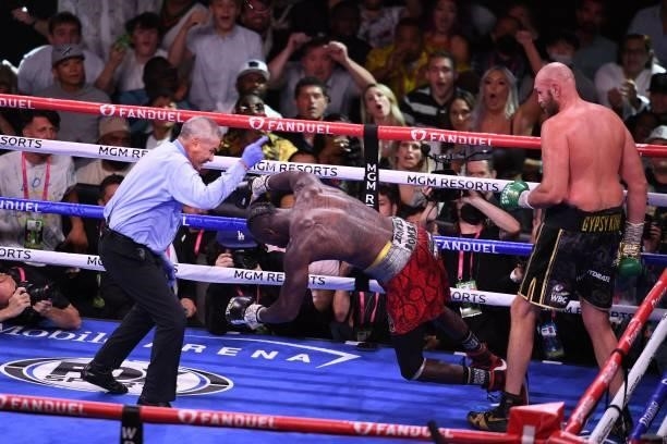 Heavyweight champion Tyson Fury of Great watches as Deontay Wilder falls to the mat after Fury delivered the knock out punch in 11th round of their...