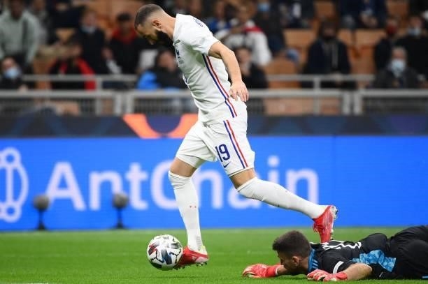 France's forward Karim Benzema vies with Spain's goalkeeper Unai Simon during the Nations League final football match between Spain and France at San...