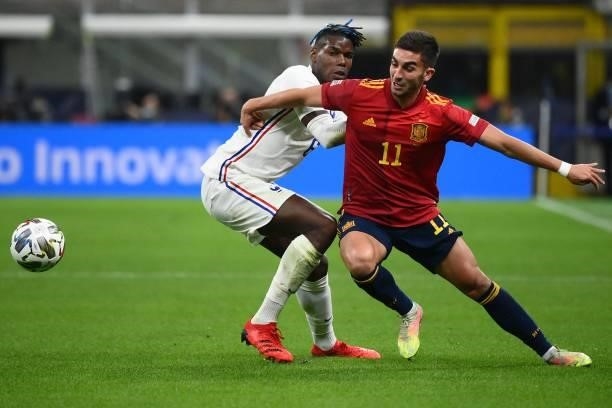 France's midfielder Paul Pogba vies with Spain's midfielder Ferran Torres during the Nations League final football match between Spain and France at...