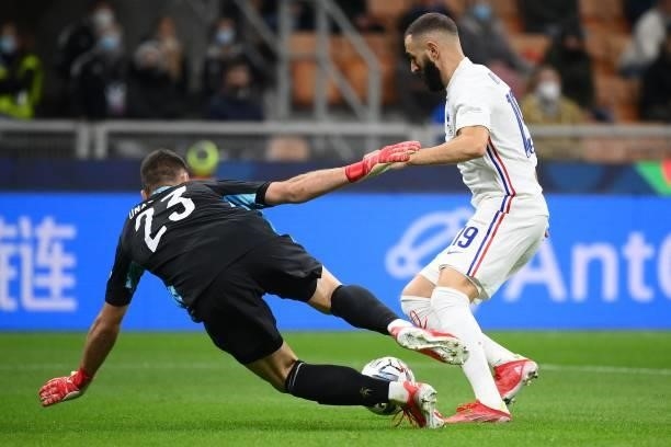 France's forward Karim Benzema vies with Spain's goalkeeper Unai Simon during the Nations League final football match between Spain and France at San...