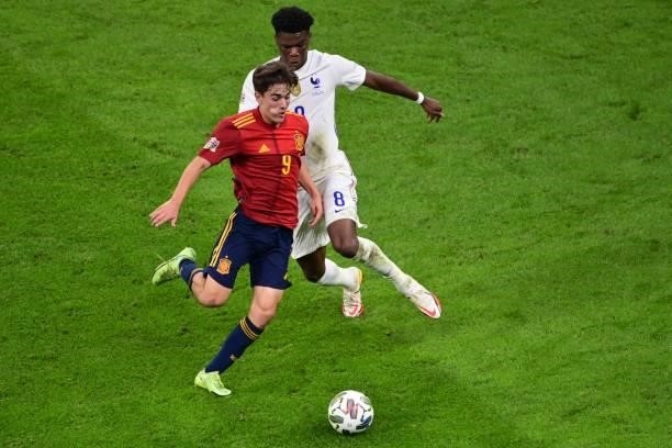 Spain's midfielder Gavi vies with France's midfielder Aurélien Tchouameni during the Nations League final football match between Spain and France at...