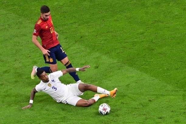 Spain's midfielder Ferran Torres vies with France's defender Presnel Kimpembe during the Nations League final football match between Spain and France...