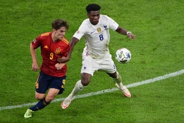 Spain's midfielder Gavi vies with France's midfielder Aurélien Tchouameni during the Nations League final football match between Spain and France at...
