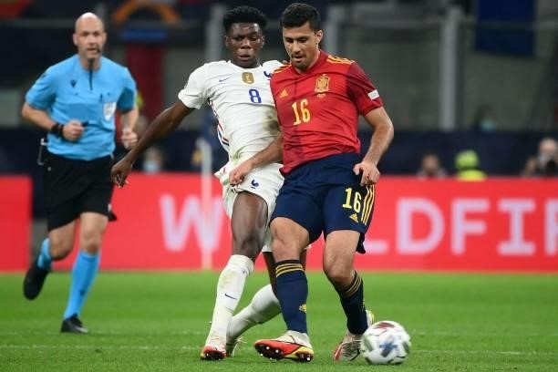 France's midfielder Aurélien Tchouameni vies with Spain's midfielder Rodri during the Nations League final football match between Spain and France at...