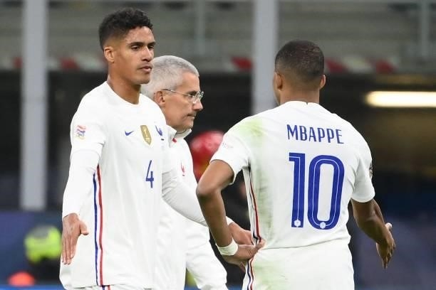 France's defender Raphael Varane shakes hands with France's forward Kylian Mbappe as he leaves the pitch after getting injured during the Nations...
