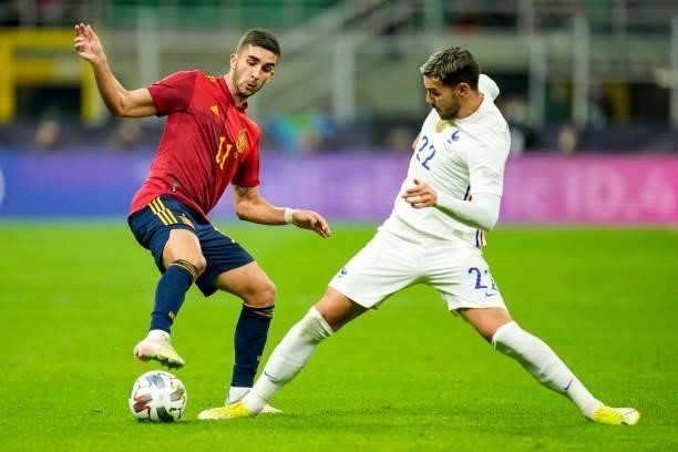 Ferran Torres of Spain and Theo Hernandez of France battle for the ball during the UEFA Nations League Final match between the Spain and France at...