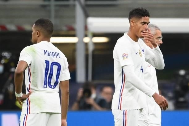 France's defender Raphael Varane leaves the pitch next to France's forward Kylian Mbappe after getting injured during the Nations League final...