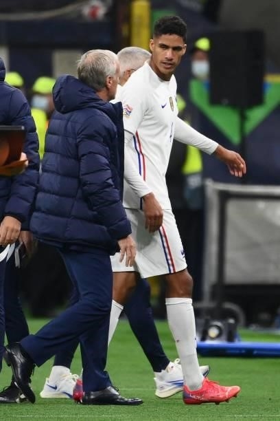 France's coach Didier Deschamps speaks with France's defender Raphael Varane as he leaves the pitch during the Nations League final football match...