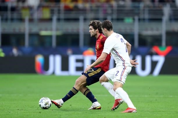 Marcos Alonso of Spain and Benjamin Pavard of France battle for the ball during the UEFA Nations League Final match between the Spain and France at...