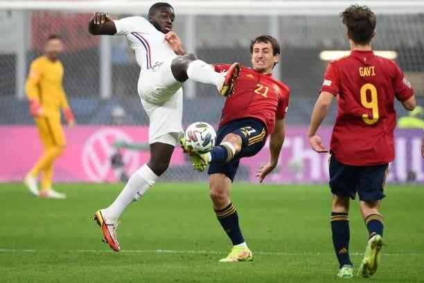 France's midfielder Dayot Upamecano vies with Spain's forward Mikel Oyarzabal during the Nations League final football match between Spain and France...