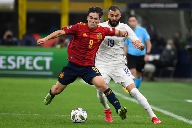 Spain's midfielder Gavi vies with France's forward Karim Benzema during the Nations League final football match between Spain and France at San Siro...