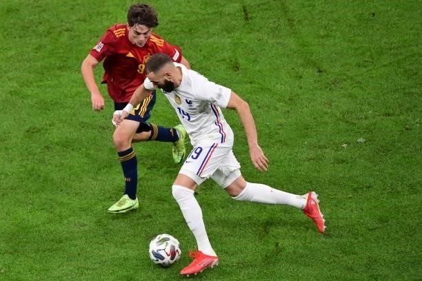 Spain's midfielder Gavi vies with France's forward Karim Benzema during the Nations League final football match between Spain and France at San Siro...