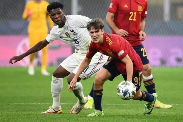 France's midfielder Aurélien Tchouameni vies with Spain's midfielder Gavi during the Nations League final football match between Spain and France at...
